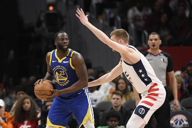 Golden State Warriors forward Draymond Green (23) handles the ball against Washington Wizards forward Davis Bertans (42) during the second half of an NBA basketball game, Monday, Feb. 3, 2020, in Washington. The Warriors won 125-117. (AP Photo/Nick Wass)