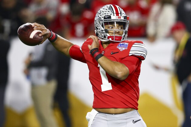Ohio State quarterback Justin Fields warms up for the team's Fiesta Bowl NCAA college football playoff semifinal against Clemson on Saturday, Dec. 28, 2019, in Glendale, Ariz. (AP Photo/Ross D. Franklin)
