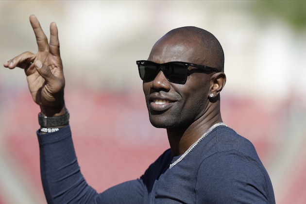 Former NFL wide receiver Terrell Owens waves to fans an NFL football game between the Tampa Bay Buccaneers and the Indianapolis Colts Sunday, Dec. 8, 2019, in Tampa, Fla. (AP Photo/Chris O'Meara)