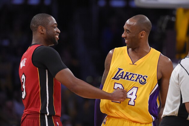 Miami Heat guard Dwyane Wade, left, and Los Angeles Lakers forward Kobe Bryant greet each other prior to an NBA basketball game Wednesday, March 30, 2016, in Los Angeles. (AP Photo/Mark J. Terrill)