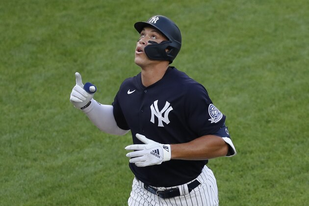 New York Yankees' Aaron Judge points skyward after hitting a solo home run during the first inning of an exhibition baseball game against the New York Mets, Sunday, July 19, 2020, at Yankee Stadium in New York. (AP Photo/Kathy Willens)