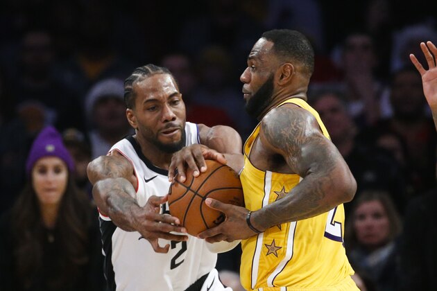 Los Angeles Lakers' LeBron James (23) and Los Angeles Clippers' Kawhi Leonard (2) fight for the ball during an NBA basketball game between Los Angeles Lakers and Los Angeles Clippers, Wednesday, Dec. 25, 2019, in Los Angeles. The Clippers won 111-106. (AP Photo/Ringo H.W. Chiu) Los Angeles Lakers' LeBron James (23) and Los Angeles Clippers' Kawhi Leonard (2) fight for the ball during an NBA basketball game between Los Angeles Lakers and Los Angeles Clippers, Wednesday, Dec. 25, 2019, in Los Angeles. The Clippers won 111-106. (AP Photo/Ringo H.W. Chiu)