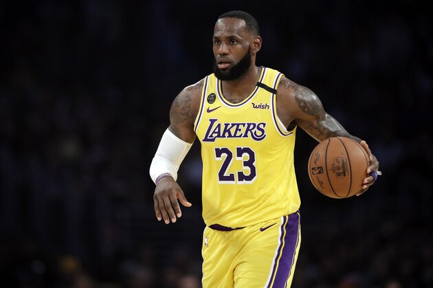 FILE - In this March 10, 2020, file photo, Los Angeles Lakers' LeBron James (23) dribbles during the first half of an NBA basketball game against the Brooklyn Nets in Los Angeles. If James gets his way, NBA arenas and other sports venues around the country will be mega polling sites for the November general election. (AP Photo/Marcio Jose Sanchez, File)