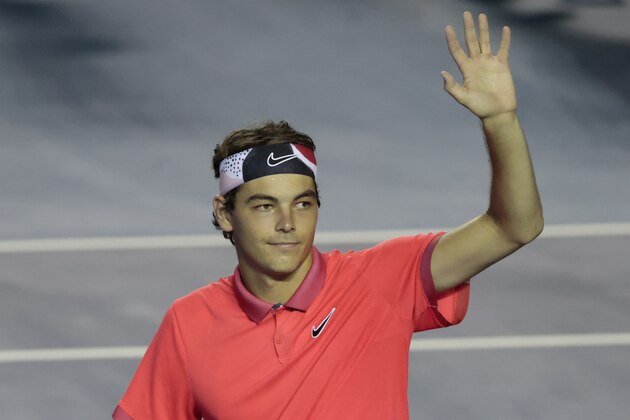 Taylor Fritz of the U.S. waves to fans after winning his semifinal match against John Isner of the U.S. at the Mexican Tennis Open in Acapulco, Mexico, Friday, Feb. 28, 2020.(AP Photo/Rebecca Blackwell)
