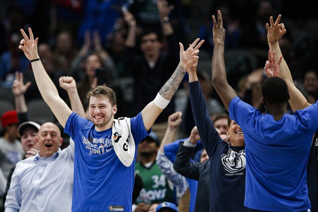 Dallas Mavericks guard Luka Doncic celebrates a three-pointer scored by Dallas Mavericks forward Boban Marjanovic, not pictured, during the second half of an NBA basketball game against the Sacramento Kings, Wednesday, Feb. 12, 2020, in Dallas. Dallas won 130-111. (AP Photo/Brandon Wade)
