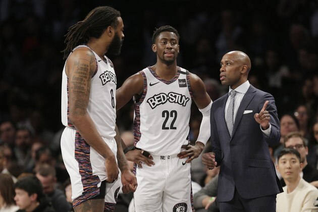 Brooklyn Nets interim head coach Jacque Vaughn, right, talks with Caris LeVert, center, and DeAndre Jordan during the second half of an NBA basketball game against the Chicago Bulls at the Barclays Center, Sunday, March 8, 2020, in New York. The Nets defeated the Bulls 110-107. (AP Photo/Seth Wenig)