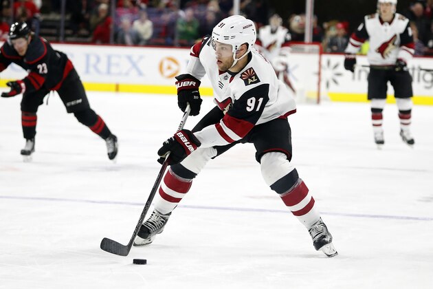Arizona Coyotes' Taylor Hall (91) moves the puck against the Carolina Hurricanes during the second period of an NHL hockey game in Raleigh, N.C., Friday, Jan. 10, 2020. (AP Photo/Karl B DeBlaker)