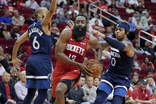 Houston Rockets guard James Harden (13) drives to the basket between Minnesota Timberwolves guard Jordans McLaughlin (6) and D'Angelo Russell (0) during the second half of an NBA basketball game Tuesday, March 10, 2020, in Houston. (AP Photo/Michael Wyke)