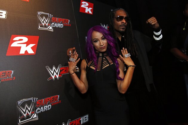IMAGE DISTRIBUTED FOR 2K GAMES - WWE Superstar Sasha Banks and DJ Snoopadelic A.K.A Snoop Dogg are seen at the WWE 2K18 SummerSlam Kickoff Event on Friday, Aug. 18, 2017, in New York. (Photo by Adam Hunger/Invision for 2K Games/AP Images)