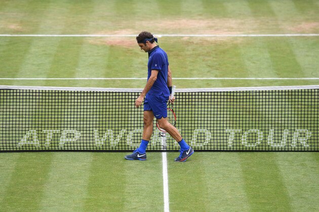 Roger Federer from Switzerland  walks nec=xt the net during his match against   Dominic  Thiem from Austria during the semifinal of the  MercedesCup ATP  tennis tournament  in Stuttgart, Germany, Saturday June 11, 2016.  (Marijan Murat/dpa via AP)