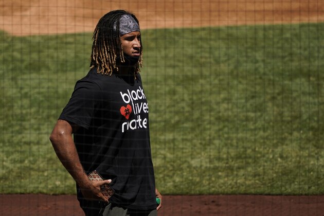 Los Angeles Angels relief pitcher Keynan Middleton wears a Black Lives Matter T-shirt as he watches baseball practice at Angel Stadium on Thursday, July 16, 2020, in Anaheim, Calif. (AP Photo/Ashley Landis)