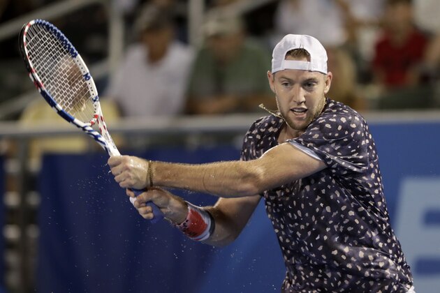 Jack Sock, of the United States, follows through on a return to Radu Albot, of Moldova, during the Delray Beach Open tennis tournament, Tuesday, Feb. 18, 2020, in Delray Beach, Fla. (AP Photo/Lynne Sladky)