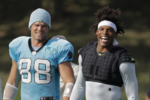 Carolina Panthers players Cam Newton, right, and Greg Olsen, left, arrive before practice at the NFL football team's training camp in Spartanburg, S.C., Sunday, July 28, 2019. (AP Photo/Chuck Burton)