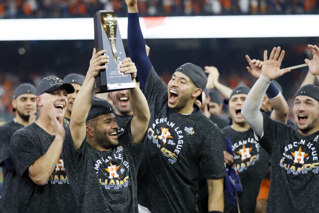 Houston Astros second baseman Jose Altuve holds the trophy after Game 6 of baseball's American League Championship Series against the New York Yankees Saturday, Oct. 19, 2019, in Houston. The Astros won 6-4 to win the series 4-2. (AP Photo/Matt Slocum)