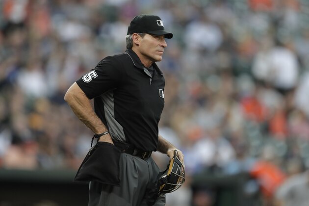 Home plate umpire Angel Hernandez looks on during the second inning of a baseball game between the Baltimore Orioles and the New York Yankees, Wednesday, Aug. 7, 2019, in Baltimore. (AP Photo/Julio Cortez)