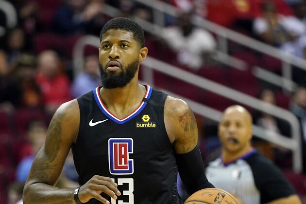 Los Angeles Clippers' Paul George (13) brings the ball up the court against the Houston Rockets during the first half of an NBA basketball game Thursday, March 5, 2020, in Houston. (AP Photo/David J. Phillip)