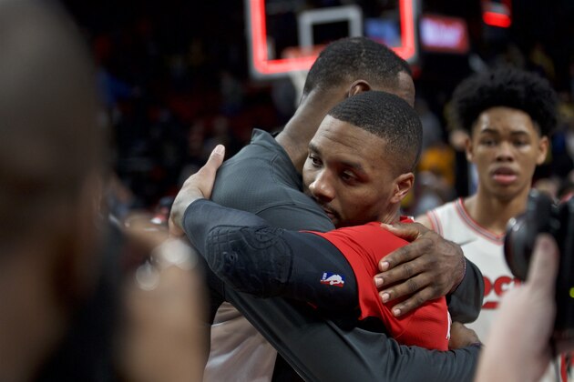 Portland Trail Blazers guard Damian Lillard, right, and Los Angeles Lakers forward LeBron James embrace after an NBA basketball game in Portland, Ore., Friday, Dec. 6, 2019. (AP Photo/Craig Mitchelldyer)