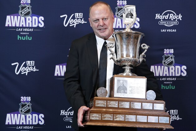 Gerard Gallant, head coach of the Vegas Golden Knights, poses with the Jack Adams Award after winning the trophy at the NHL Awards, Wednesday, June 20, 2018, in Las Vegas. (AP Photo/John Locher)