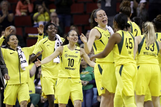 File-This June 15, 2018, file photo shows Seattle Storm's Alysha Clark, left, Natasha Howard, Sue Bird (10) and Breanna Stewart coming off the bench to greet teammates during a timeout in the first half of a WNBA basketball game against the Connecticut Sun in Seattle. About the only thing that has been decided when it comes to the postseason is Seattle will have a bye to the semifinals. Atlanta is close to wrapping up a top two seed, but finishes the season with two more games on the road. Washington, Connecticut, Los Angeles, Phoenix and Minnesota are all jockeying for a first-round bye. (AP Photo/Elaine Thompson, File)