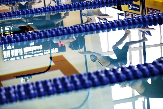 Kentucky's Geena Freriks is reflected on the starting block before diving into the pool for the 800-yard freestyle relay at the NCAA women's swimming and diving championships at Georgia Tech Wednesday, March 16, 2016, in Atlanta. (AP Photo/David Goldman)