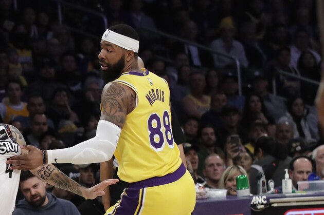 Brooklyn Nets' Chris Chiozza, left, is defended by Los Angeles Lakers' Markieff Morris during the second half of an NBA basketball game Tuesday, March 10, 2020, in Los Angeles. (AP Photo/Marcio Jose Sanchez)