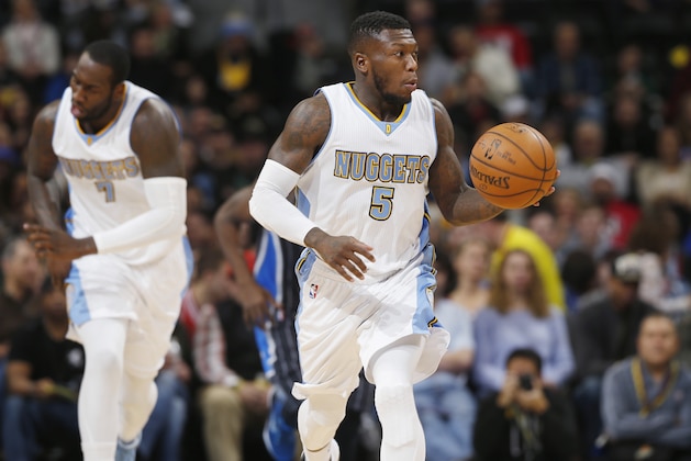 Denver Nuggets guard Nate Robinson brings the ball up the court against the Orlando Magic in the first quarter of an NBA basketball game Wednesday, Jan. 7, 2015, in Denver. (AP Photo/David Zalubowski)