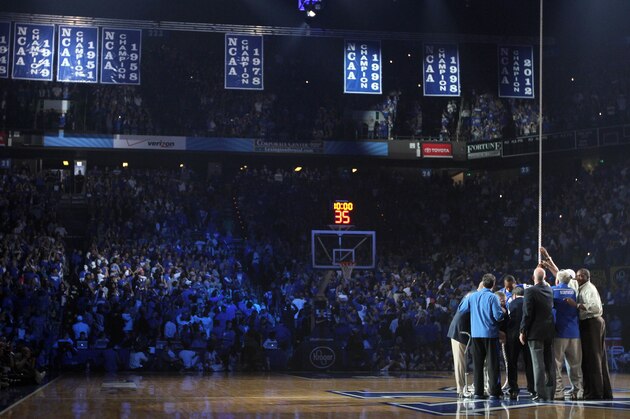 Memebers of Kentucky's previous national championship teams re-raise the banners during Kentucky's NCAA college basketball Big Blue Madness at Rupp Arena in Lexington, Ky., Friday, Oct. 12, 2012. (AP Photo/James Crisp)