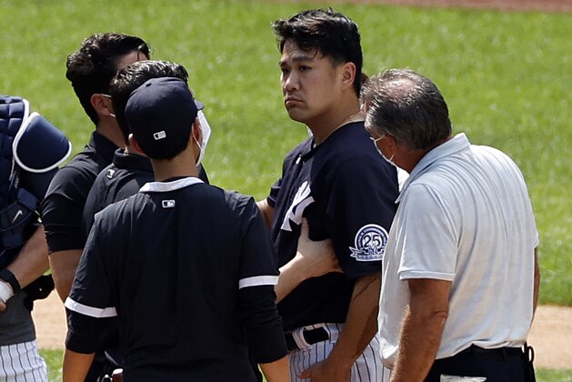 New York Yankees pitcher Masahiro Tanaka is tended to by team medical personnel after being hit by a ball off the bat of Yankees Giancarlo Stanton during a baseball a workout at Yankee Stadium in New York, Saturday, July 4, 2020. (AP Photo/Adam Hunger) New York Yankees pitcher Masahiro Tanaka is tended to by team medical personnel after being hit by a ball off the bat of Yankees Giancarlo Stanton during a baseball a workout at Yankee Stadium in New York, Saturday, July 4, 2020. (AP Photo/Adam Hunger)