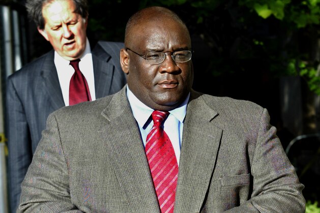 FILE- In this April 28, 2005 file photo, then University of Nebraska defensive line coach, and former Oklahoma University head coach John Blake, right, arrives at the Cleveland County Courthouse in Norman, Okla. Former North Carolina assistant coach John Blake says he never worked to steer players to late NFL agent Gary Wichard in an interview with Sports Illustrated released Wednesday, Oct. 26, 2011.  Blake plans to attend the school's hearing Friday with the NCAA infractions committee in Indianapolis after being accused of guiding players to Wichard. (AP Photo/File)