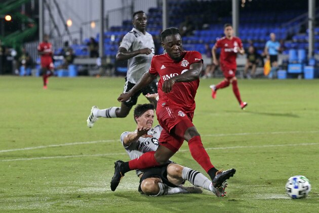 Toronto FC forward Ayo Akinola, front, scores his second goal of the game during the first half of an MLS soccer match against the Montreal Impact, Thursday, July 16, 2020, in Kissimmee, Fla. (AP Photo/John Raoux) Toronto FC forward Ayo Akinola, front, scores his second goal of the game during the first half of an MLS soccer match against the Montreal Impact, Thursday, July 16, 2020, in Kissimmee, Fla. (AP Photo/John Raoux)
