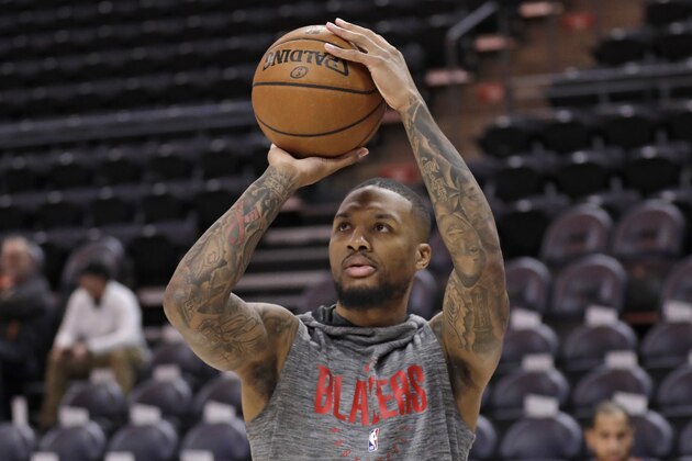 Portland Trail Blazers guard Damian Lillard warms up for the team's NBA basketball game against the Utah Jazz on Friday, Feb. 7, 2020, in Salt Lake City. (AP Photo/Rick Bowmer)