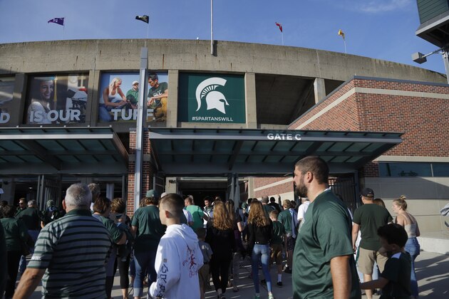 Michigan State fans wait to enter Spartan Stadium before the start of an NCAA college football game between Michigan State and Tulsa, Friday, Aug. 30, 2019, in East Lansing, Mich. (AP Photo/Al Goldis)
