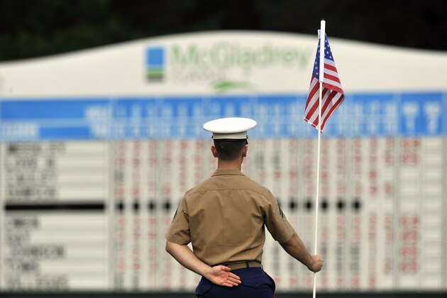A United State Marine holds the flag from the 9th hole during the The McGladrey Classic military appreciation day on the first round of PGA Tour golf tournament Thursday, Oct. 18, 2012 in St. Simons Island, Ga. (AP Photo/Stephen Morton)
