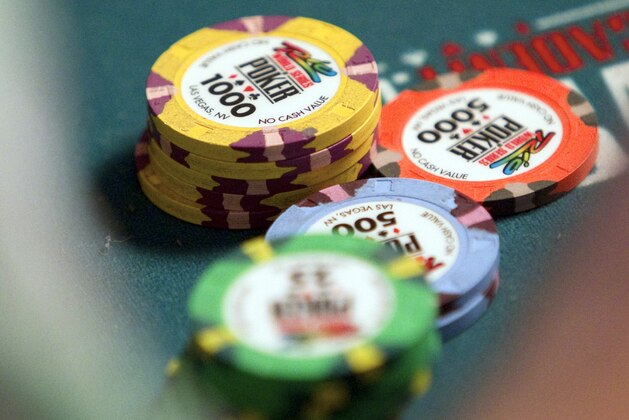Poker chips rest on a table where Mclean Karr competes on the first day of the World Series of Poker, Thursday, July 7, 2011, at the Rio All-Suite Hotel & Casino in Las Vegas. The $10,000 buy-in, no-limit Texas Hold `em tournament kicked off with the first of four starting days, expected to attract thousands of players to combine for millions in prize money for the winner. (AP Photo/Eric Jamison)