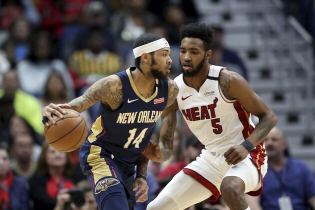 New Orleans Pelicans forward Brandon Ingram (14) dribbles as Miami Heat forward Derrick Jones Jr. (5) defends during the first half of an NBA basketball game in New Orleans, Friday, March 6, 2020. (AP Photo/Rusty Costanza)