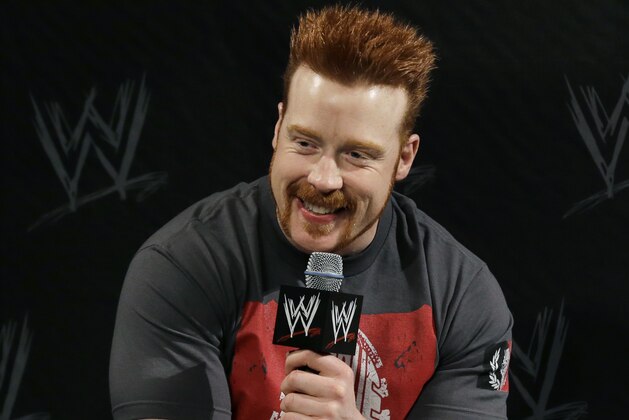 WWE wrestling star Stephen Farrelly,  of Ireland, know as Sheamus, smiles as he answers a question during a news conference Sunday, April 7, 2013, in East Rutherford, N.J., ahead of Sunday's WWE Wrestlemania 29. (AP Photo/Mel Evans)