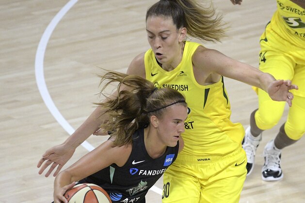 New York Liberty forward Sabrina Ionescu (20) drives past Seattle Storm forward Breanna Stewart (30) during the first half of a WNBA basketball game, Saturday, July 25, 2020, in Ellenton, Fla. (AP Photo/Phelan M. Ebenhack)