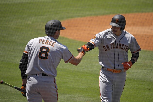 San Francisco Giants' Wilmer Flores, right, is congratulated by Hunter Pence after hitting a solo home run during the third inning of a baseball game against the Los Angeles Dodgers Saturday, July 25, 2020, in Los Angeles. (AP Photo/Mark J. Terrill) San Francisco Giants' Wilmer Flores, right, is congratulated by Hunter Pence after hitting a solo home run during the third inning of a baseball game against the Los Angeles Dodgers Saturday, July 25, 2020, in Los Angeles. (AP Photo/Mark J. Terrill)