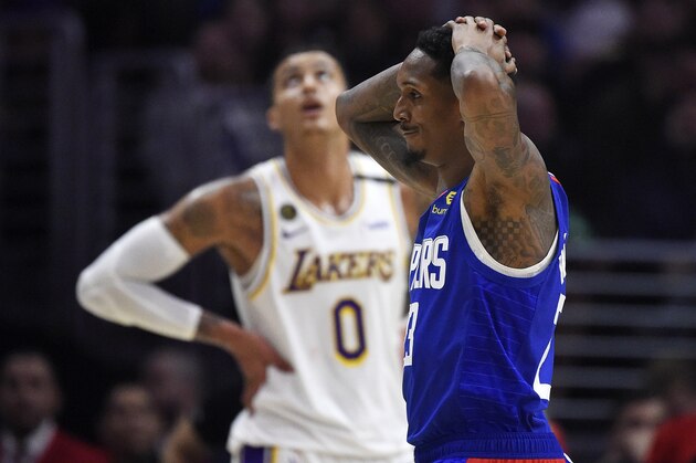 Los Angeles guard Lou Williams, reacts after they were called for a foul as Los Angeles Lakers forward Kyle Kuzma stands in the background during the second half of an NBA basketball game Sunday, March 8, 2020, in Los Angeles. The Lakers won 112-103. (AP Photo/Mark J. Terrill)
