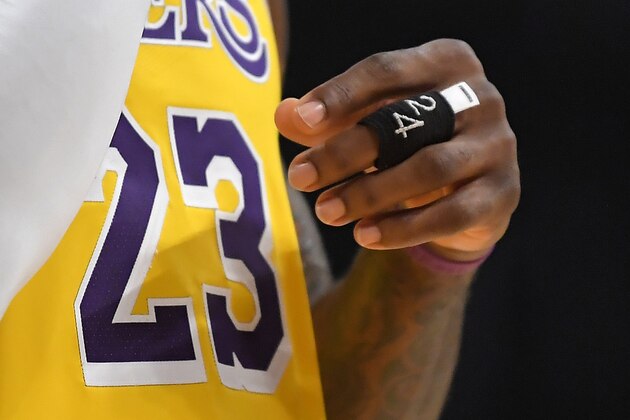 Los Angeles Lakers forward LeBron James' hand is seen with a wrap that features Kobe Bryant's number on it during the second half of an NBA basketball game against the Houston Rockets, Thursday, Feb. 6, 2020, in Los Angeles. The Rockets won 121-111. (AP Photo/Mark J. Terrill)
