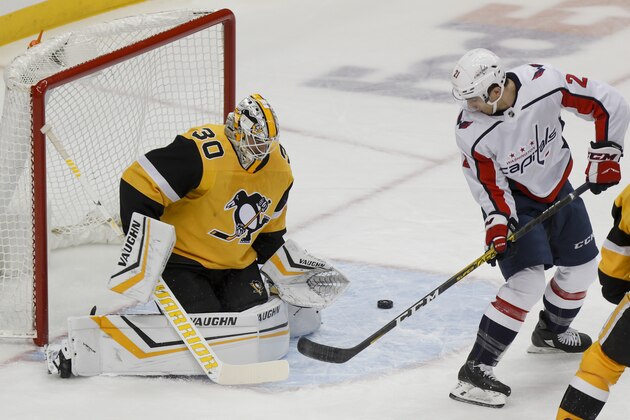 Washington Capitals' Garnet Hathaway (21) tries to direct the puck as Pittsburgh Penguins goaltender Matt Murray (30) defends during the first period of an NHL hockey game, Saturday, March 7, 2020, in Pittsburgh. (AP Photo/Keith Srakocic)