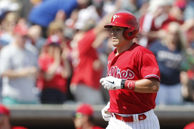 Philadelphia Phillies' J.T. Realmuto scores during a spring training baseball game, Wednesday, March 4, 2020, in Clearwater, Fla. (AP Photo/Carlos Osorio)