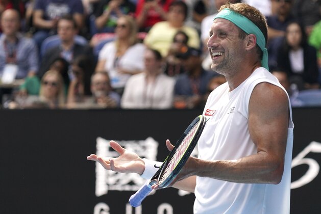 Tennys Sandgren of the U.S. reacts during his quarterfinal match against Switzerland's Roger Federer at the Australian Open tennis championship in Melbourne, Australia, Tuesday, Jan. 28, 2020. (AP Photo/Lee Jin-man)