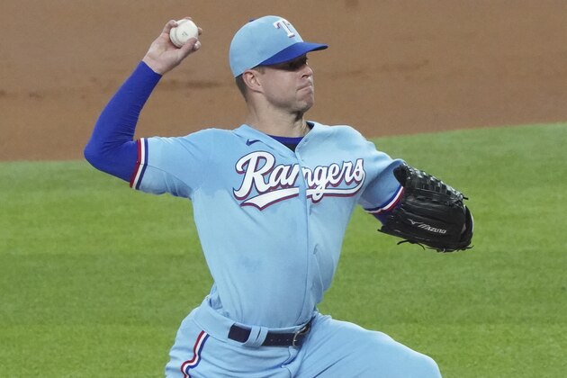 Texas Rangers starting pitcher Corey Kluber throws against the Colorado Rockies in the first inning of a baseball game Sunday, July 26, 2020, in Arlington, Texas. Kluber was removed from the game after one inning. (AP Photo/Louis DeLuca)