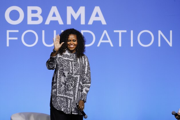 Former U.S. fist lady Michelle Obama waves as she attends an event for Obama Foundation in Kuala Lumpur, Malaysia, Thursday, Dec. 12, 2019. Obama and actress Julia Roberts attended the inaugural Gathering of Rising Leaders in the Asia Pacific organized by the Obama Foundation. (AP Photo/Vincent Thian)