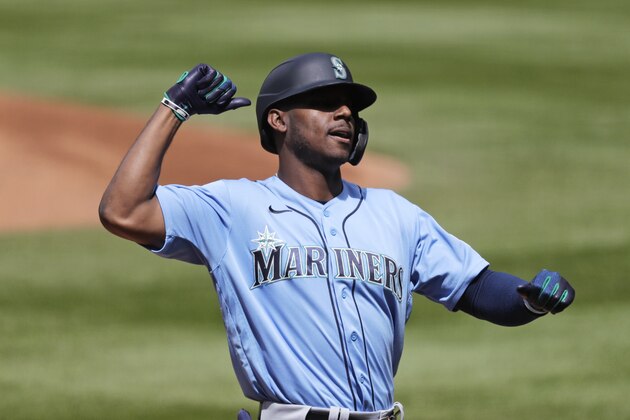 Seattle Mariners' Kyle Lewis gets ready to share congratulations with a teammate as he heads home on his two-run home run during a