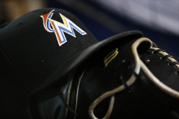 A Miami Marlins hat sits atop a baseball glove against the Washington Nationals, Sunday, July 29, 2018, in Miami. (AP Photo/Brynn Anderson)