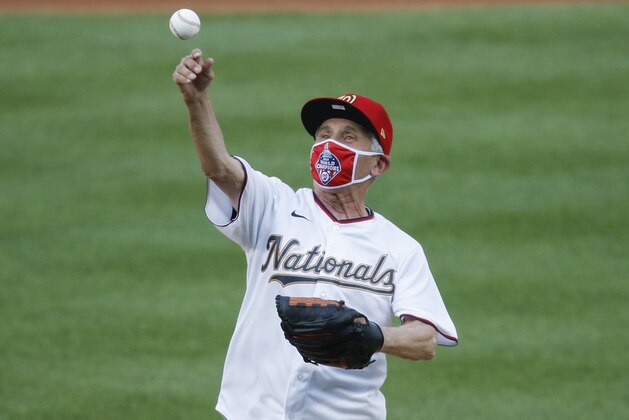 Ceremonial first pitch is thrown by Dr. Anthony Fauci, Director of the National Institute of Allergy and Infectious Diseases before the start of the during the first inning of an opening day baseball game between the New York Yankees and Washington Nationals at Nationals Park, Thursday, July 23, 2020, in Washington. (AP Photo/Alex Brandon) Ceremonial first pitch is thrown by Dr. Anthony Fauci, Director of the National Institute of Allergy and Infectious Diseases before the start of the during the first inning of an opening day baseball game between the New York Yankees and Washington Nationals at Nationals Park, Thursday, July 23, 2020, in Washington. (AP Photo/Alex Brandon)