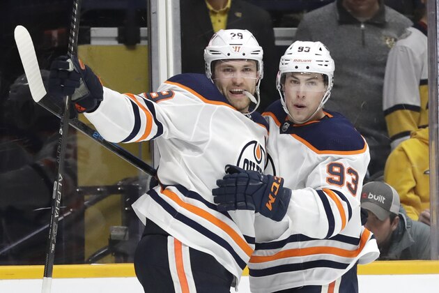 Edmonton Oilers center Leon Draisaitl (29), of Germany, celebrates with Ryan Nugent-Hopkins (93) after Draisaitl scored his second goal of the game against the Nashville Predators in the third period of an NHL hockey game Monday, March 2, 2020, in Nashville, Tenn. (AP Photo/Mark Humphrey) Edmonton Oilers center Leon Draisaitl (29), of Germany, celebrates with Ryan Nugent-Hopkins (93) after Draisaitl scored his second goal of the game against the Nashville Predators in the third period of an NHL hockey game Monday, March 2, 2020, in Nashville, Tenn. (AP Photo/Mark Humphrey)