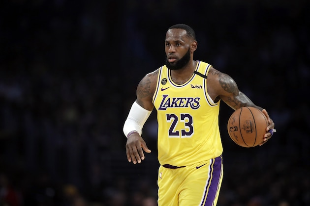 FILE - In this March 10, 2020, file photo, Los Angeles Lakers' LeBron James (23) dribbles during the first half of an NBA basketball game against the Brooklyn Nets in Los Angeles. If James gets his way, NBA arenas and other sports venues around the country will be mega polling sites for the November general election. (AP Photo/Marcio Jose Sanchez, File) FILE - In this March 10, 2020, file photo, Los Angeles Lakers' LeBron James (23) dribbles during the first half of an NBA basketball game against the Brooklyn Nets in Los Angeles. If James gets his way, NBA arenas and other sports venues around the country will be mega polling sites for the November general election. (AP Photo/Marcio Jose Sanchez, File)